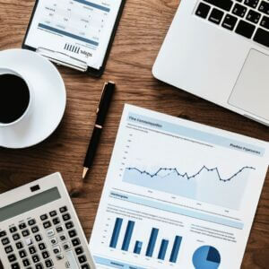 accounting tools on a desk, laptop, calculator,graphs and charts