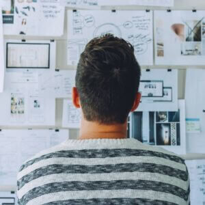 young man looking at vision board