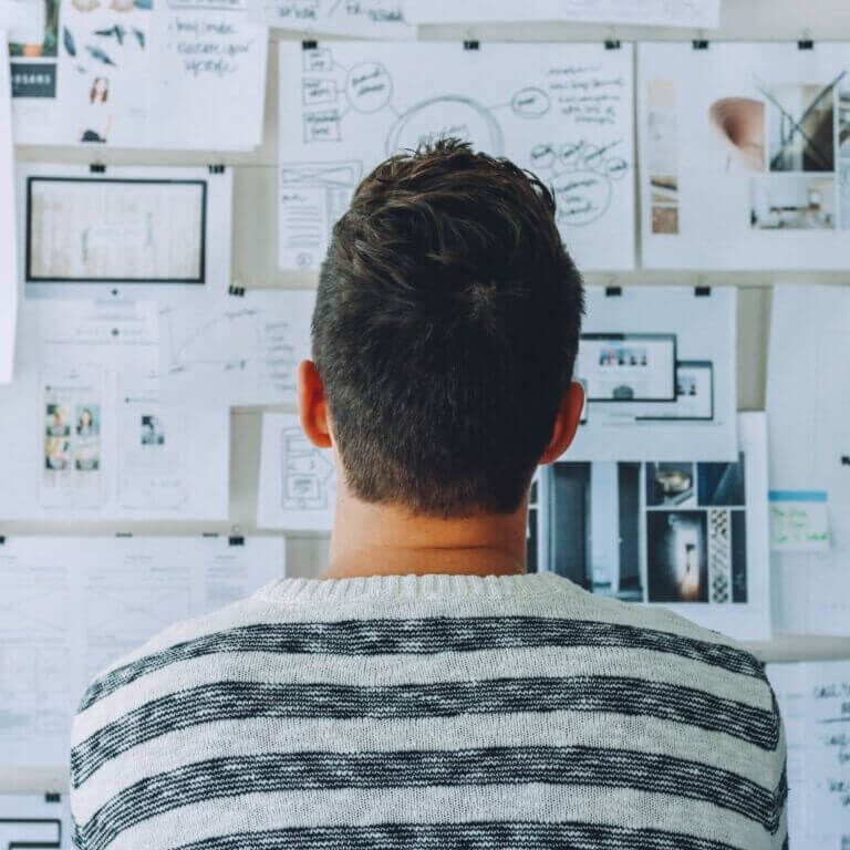 young man looking at vision board